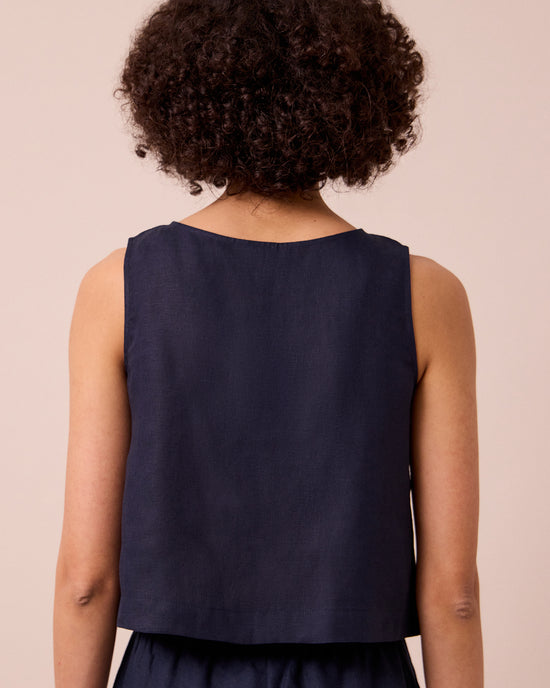 model wears esme navy linen top