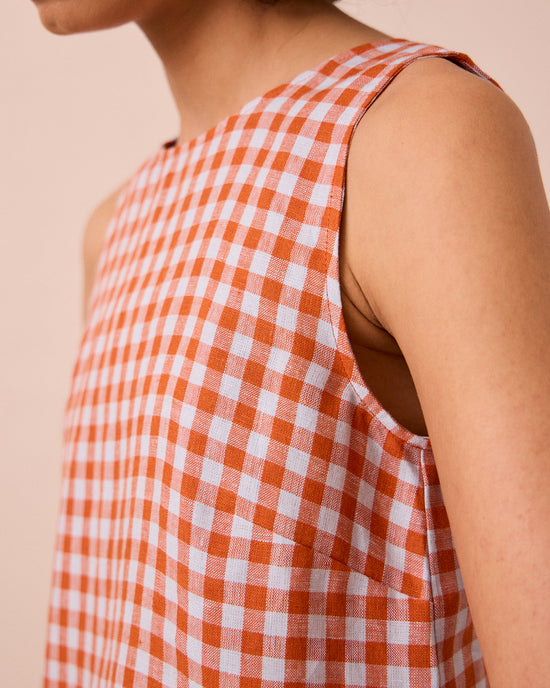 model wears esme burnt orange gingham linen top