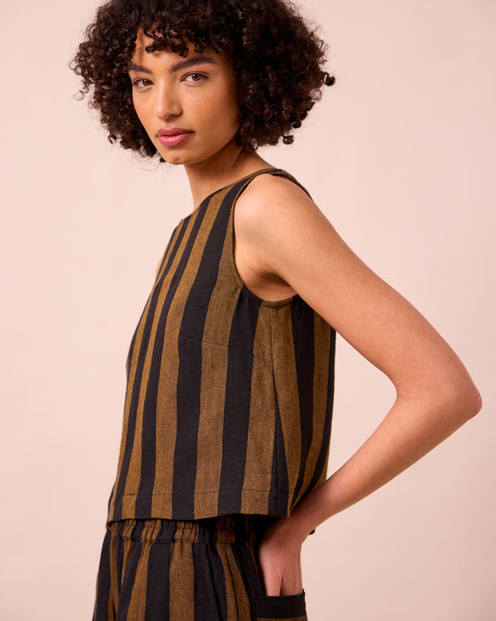 model wears esme rust stripe linen top