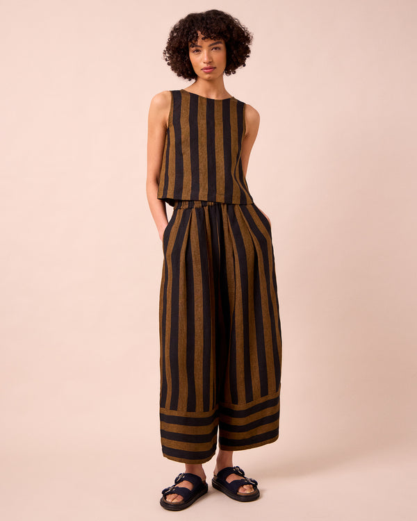 model wears esme rust stripe linen top