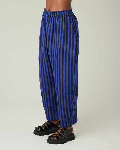 model wears indigo stripe linen mabel trousers from the left side