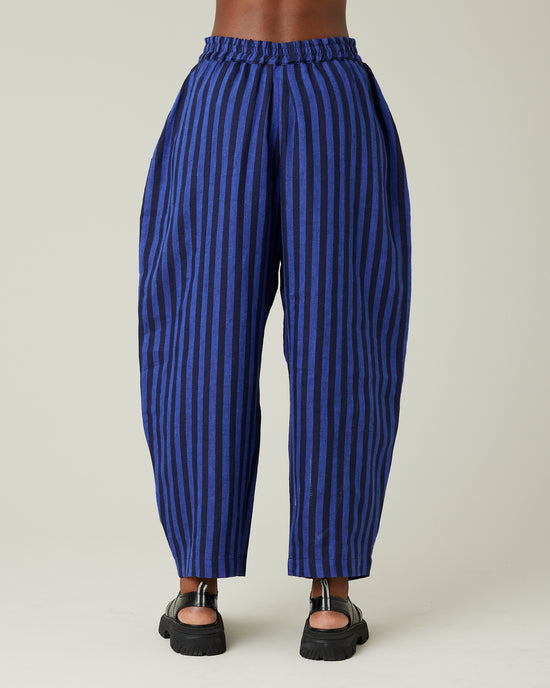 model wears indigo stripe linen mabel trousers from the back