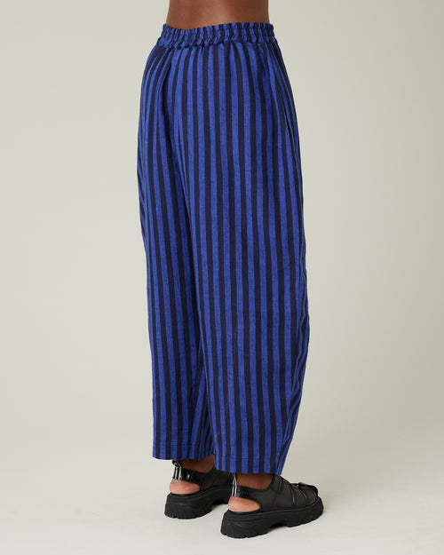 model wears indigo stripe linen mabel trousers from the right side