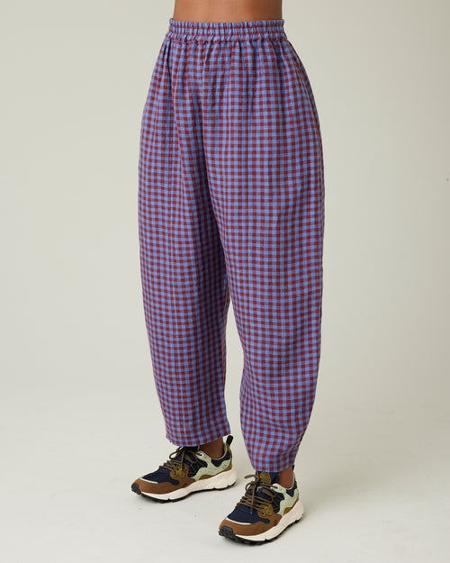 model wears blueberry check linen trousers from the left side