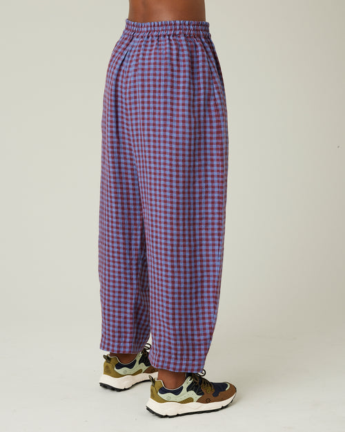 model wears blueberry check linen trousers to the right side