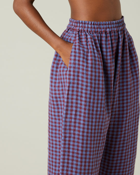 model wears blueberry check linen trousers