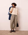 model wears mabel olive gingham linen trousers