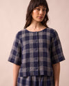 model wears evelyn navy plaid linen top