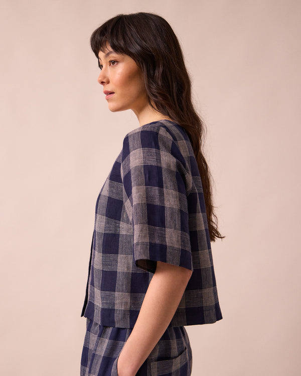 model wears evelyn navy plaid linen top