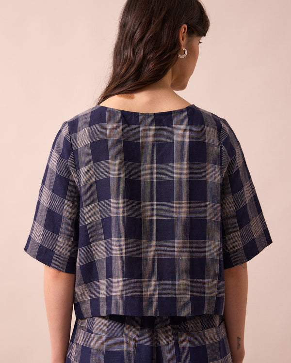 model wears evelyn navy plaid linen top