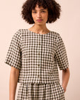 model wears evelyn olive gingham linen top
