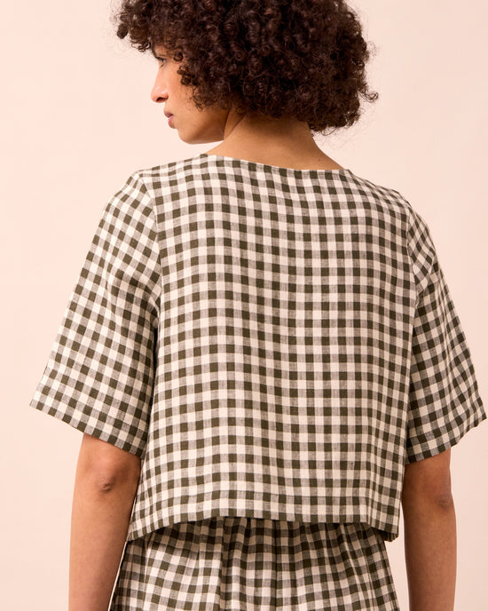 model wears evelyn olive gingham linen top