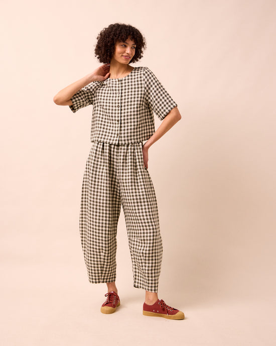 model wears evelyn olive gingham linen top
