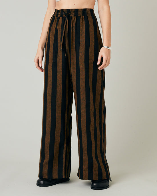 model wears rust stripe lexi linen trousers front