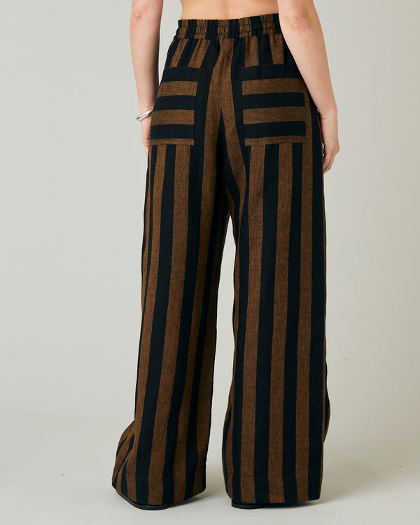 model wears rust stripe lexi linen trousers back