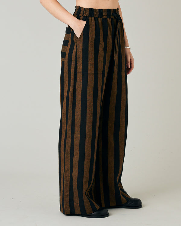 model wears rust stripe lexi linen trousers right