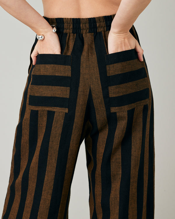 model wears rust stripe lexi linen trousers