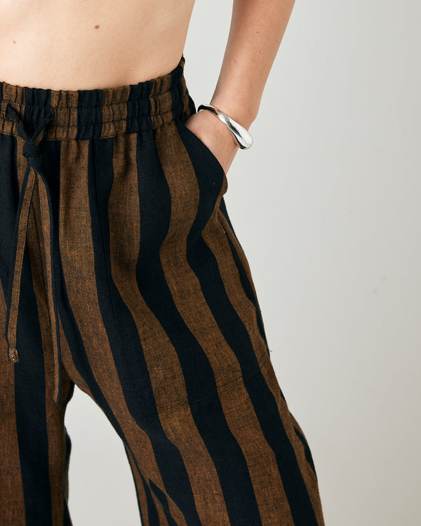 model wears rust stripe lexi linen trousers