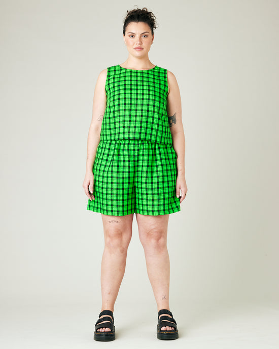 model wears green and black check ari shorts