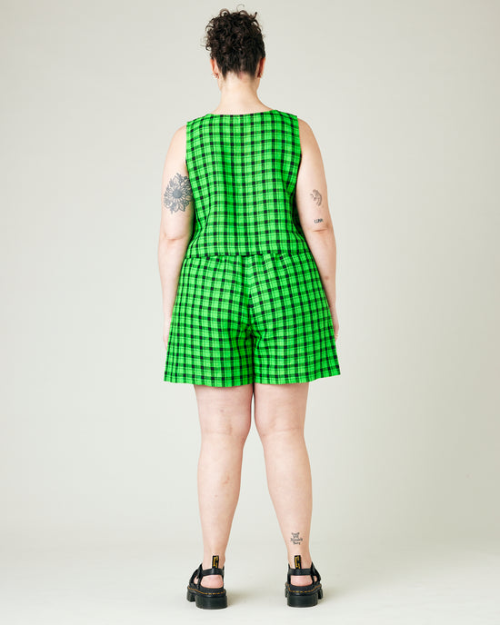 model wears green and black check ari shorts