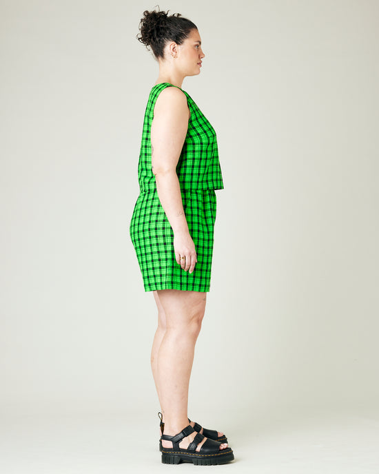 model wears green and black check ari shorts