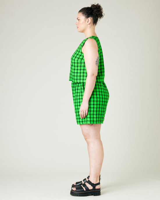 model wears green and black check ari shorts