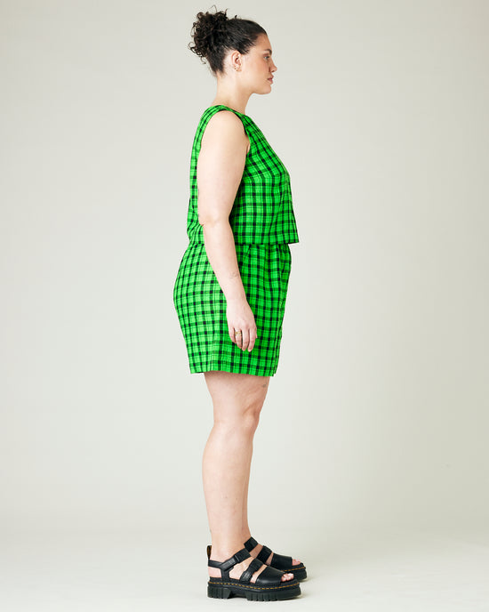 model wears green and black check ari shorts