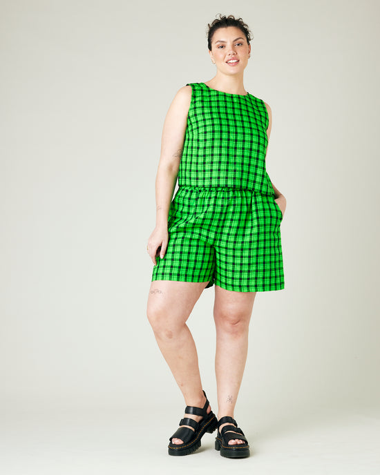 model wears green and black check ari shorts