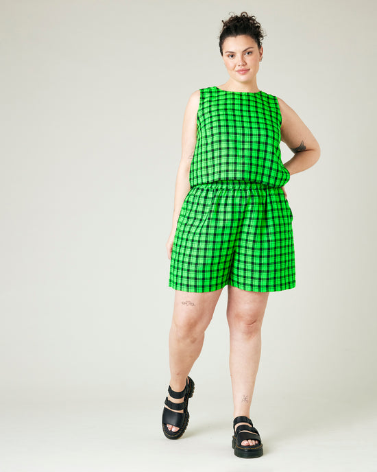 model wears green and black check ari shorts