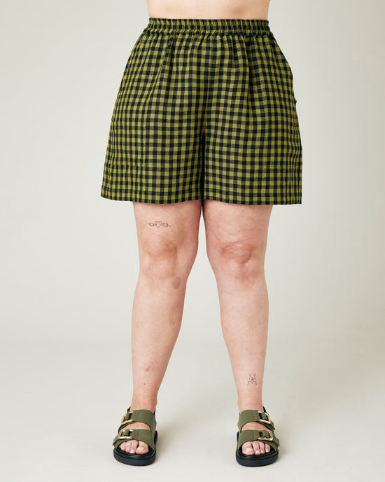 model wears green gingham ari shorts