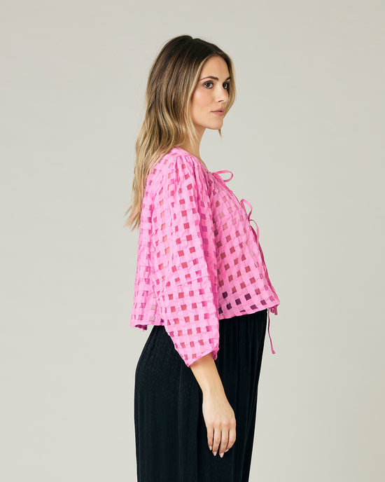 pregnant model wears pink organza fleur top