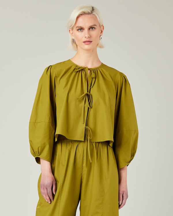 model wears olive poplin fleur top 