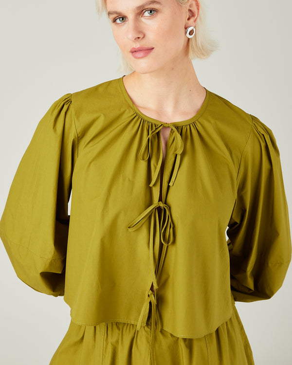 model wears olive poplin fleur top 