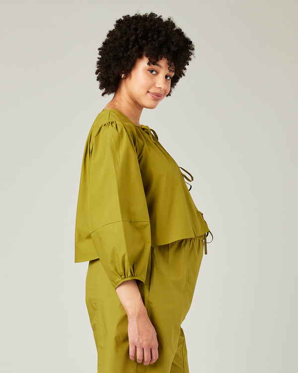 pregnant model wears olive poplin fleur top 