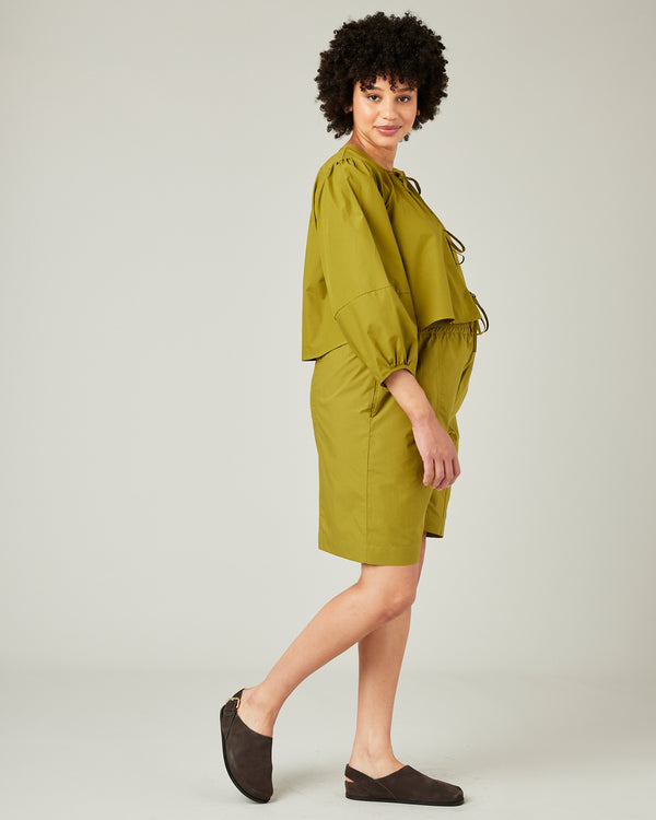pregnant model wears olive poplin fleur top 