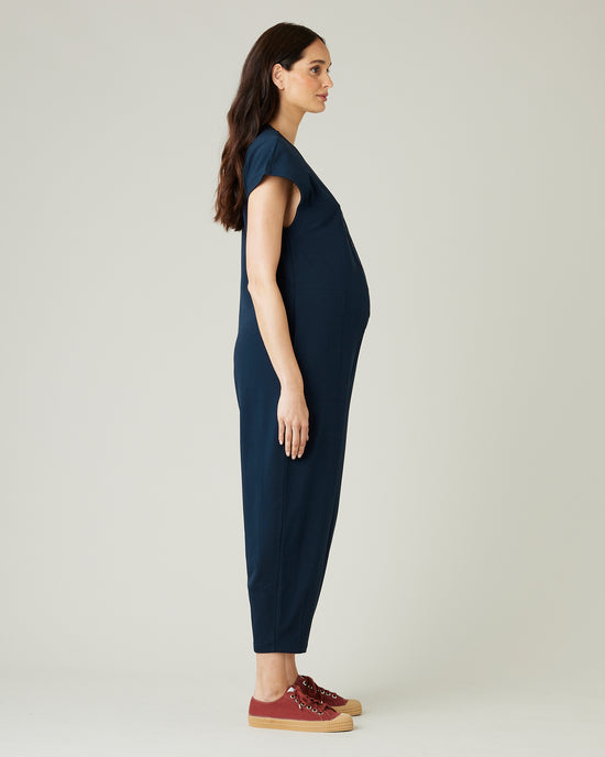 pregnant model wears navy jersey frankie jumpsuit