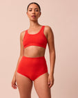 model wears tomato red full coverage jersey knicker
