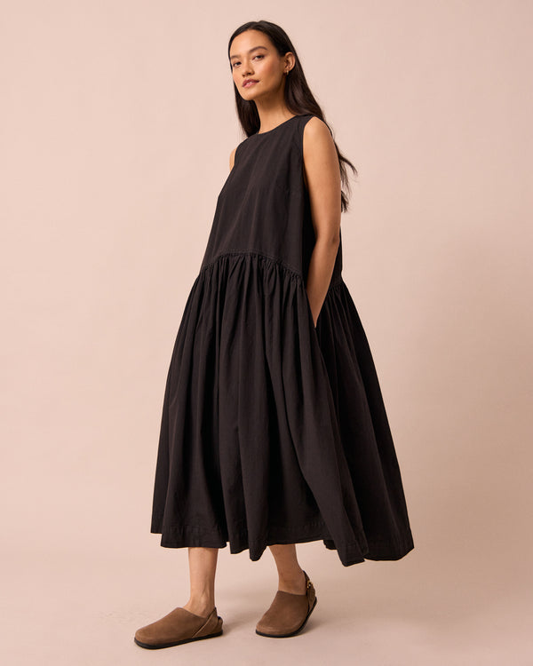 model wears gina black cotton poplin dress