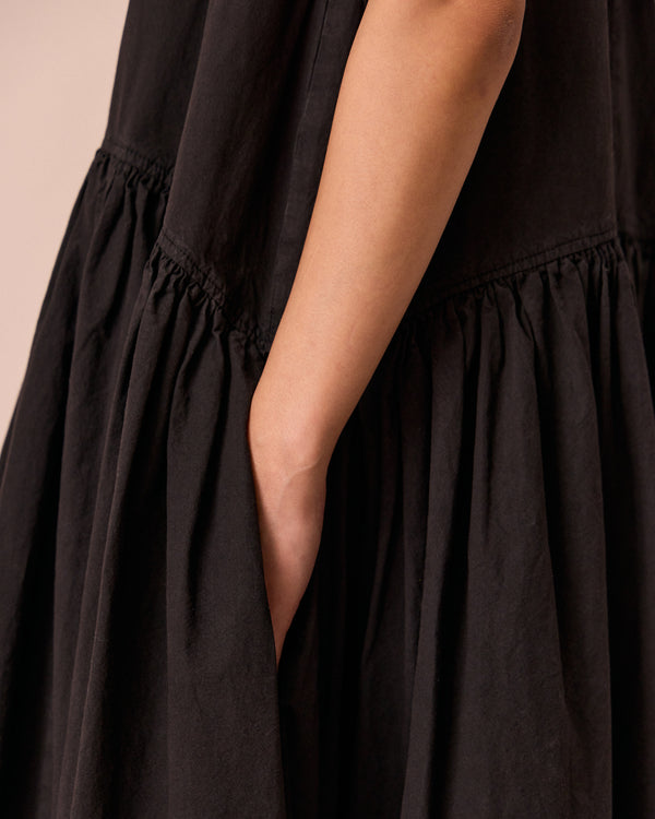 model wears gina black cotton poplin dress
