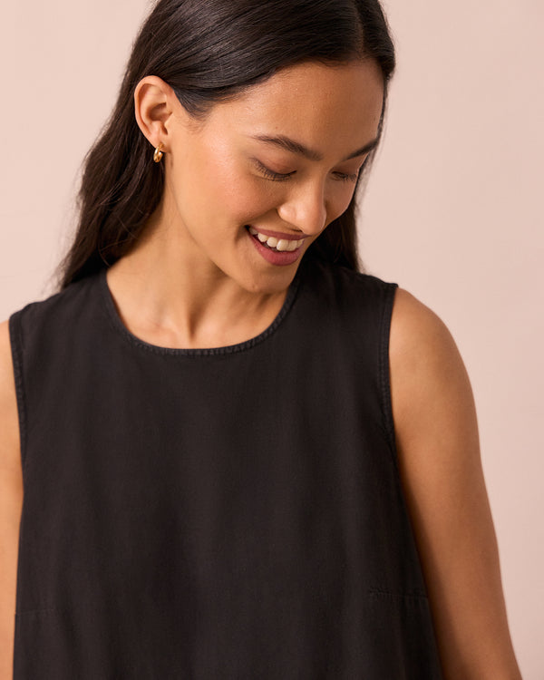 model wears gina black cotton poplin dress
