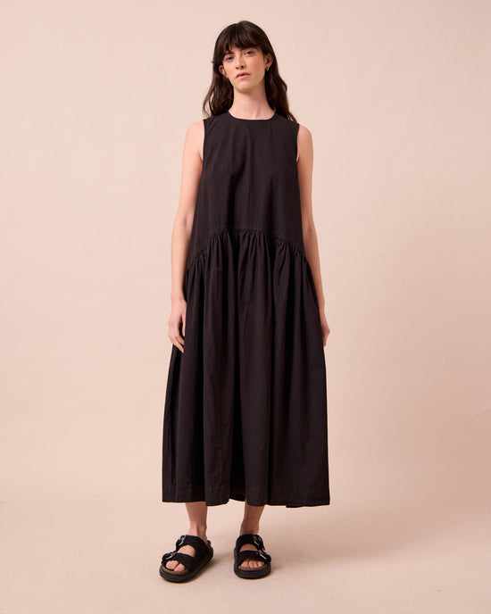 model wears gina washed black cotton poplin dress