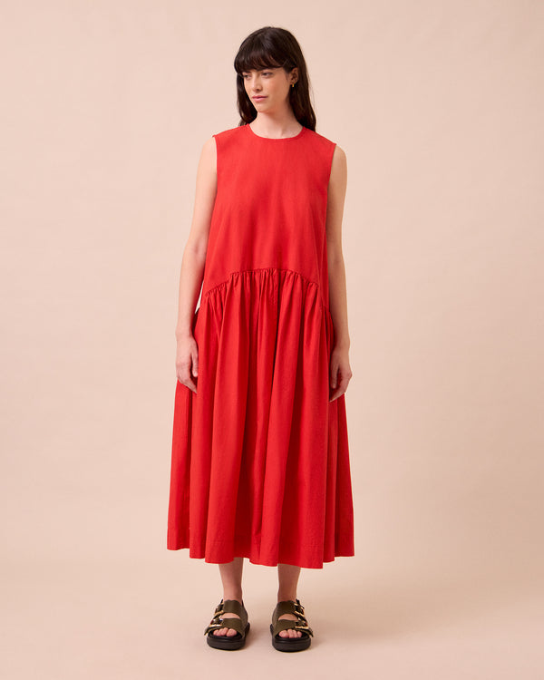 model wears gins chilli red cotton poplin dress