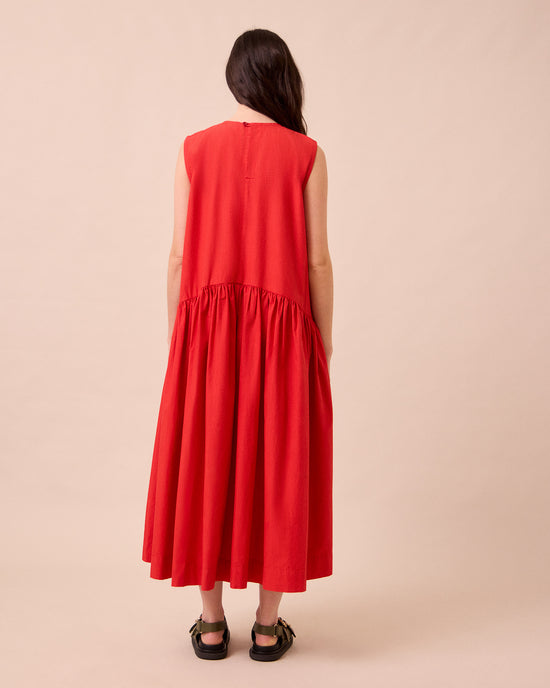 model wears gins chilli red cotton poplin dress