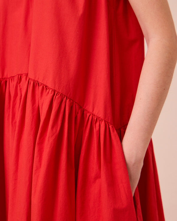 model wears gins chilli red cotton poplin dress