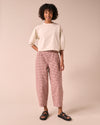 model wears remi taffy mini gingham denim jeans left