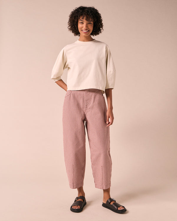 model wears remi taffy mini gingham denim jeans left