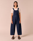 model wears gwynne dark wash denim dungerees