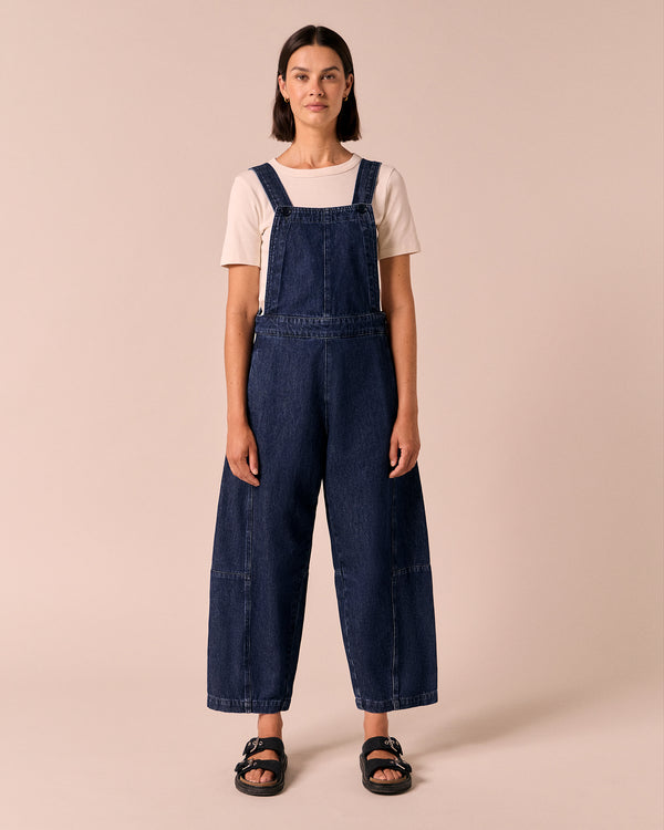 model wears gwynne dark wash denim dungerees