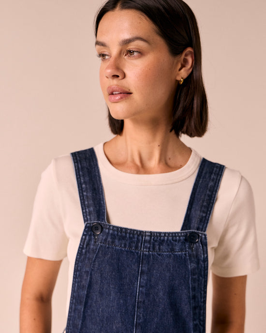 model wears gwynne dark wash denim dungerees