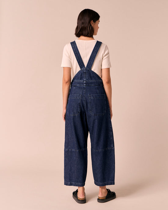 model wears gwynne dark wash denim dungerees